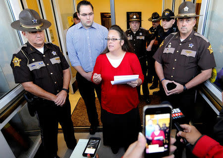 FILE PHOTO: Kim Davis, the Kentucky county clerk who refused to issue same-sex marriage licenses, addresses the media just before the doors are opened to the Rowan County Clerk's Office in Morehead, Kentucky, U.S. on September 14, 2015. REUTERS/Chris Tilley/File Photo