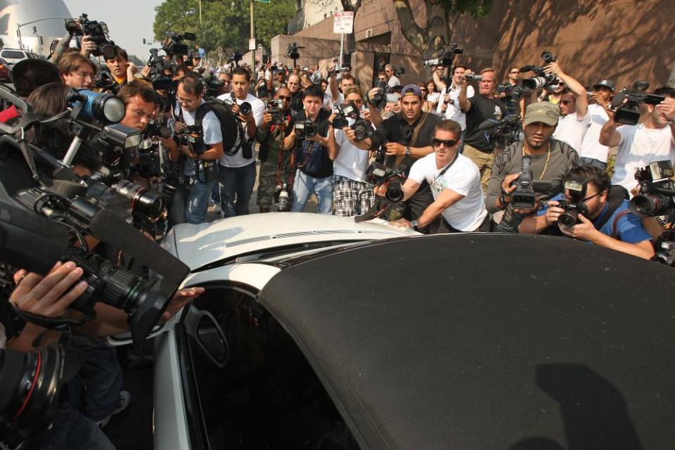 Mobbed … photographers surround Britney’s car as she arrives at court in 2007.