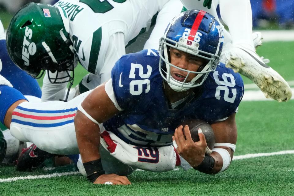 October 29, 2023; East Rutherford, NJ, USA; New York Giants running back Saquon Barkley (26) is shown with the ball in the second quarter.