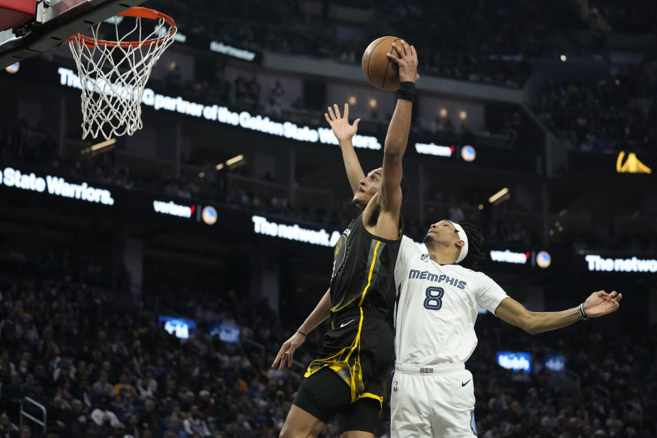 Golden State Warriors guard Jordan Poole (3) shoots while defended by Memphis Grizzlies forward Ziaire Williams (8) during the first half of an NBA basketball game in San Francisco, Sunday, Dec. 25, 2022. (AP Photo/Godofredo A. Vásquez)