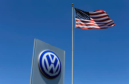 FILE PHOTO: A U.S. flag flutters in the wind above a Volkswagen dealership in Carlsbad, California, U.S. May 2, 2016. REUTERS/Mike Blake/File Photo