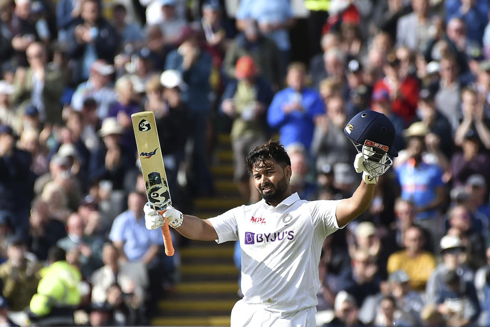 India's Rishabh Pant raises his bat and helmet to celebrate scoring a century during the first day of the fifth cricket test match between England and India at Edgbaston in Birmingham, England, Friday, July 1, 2022. (AP Photo/Rui Vieira)