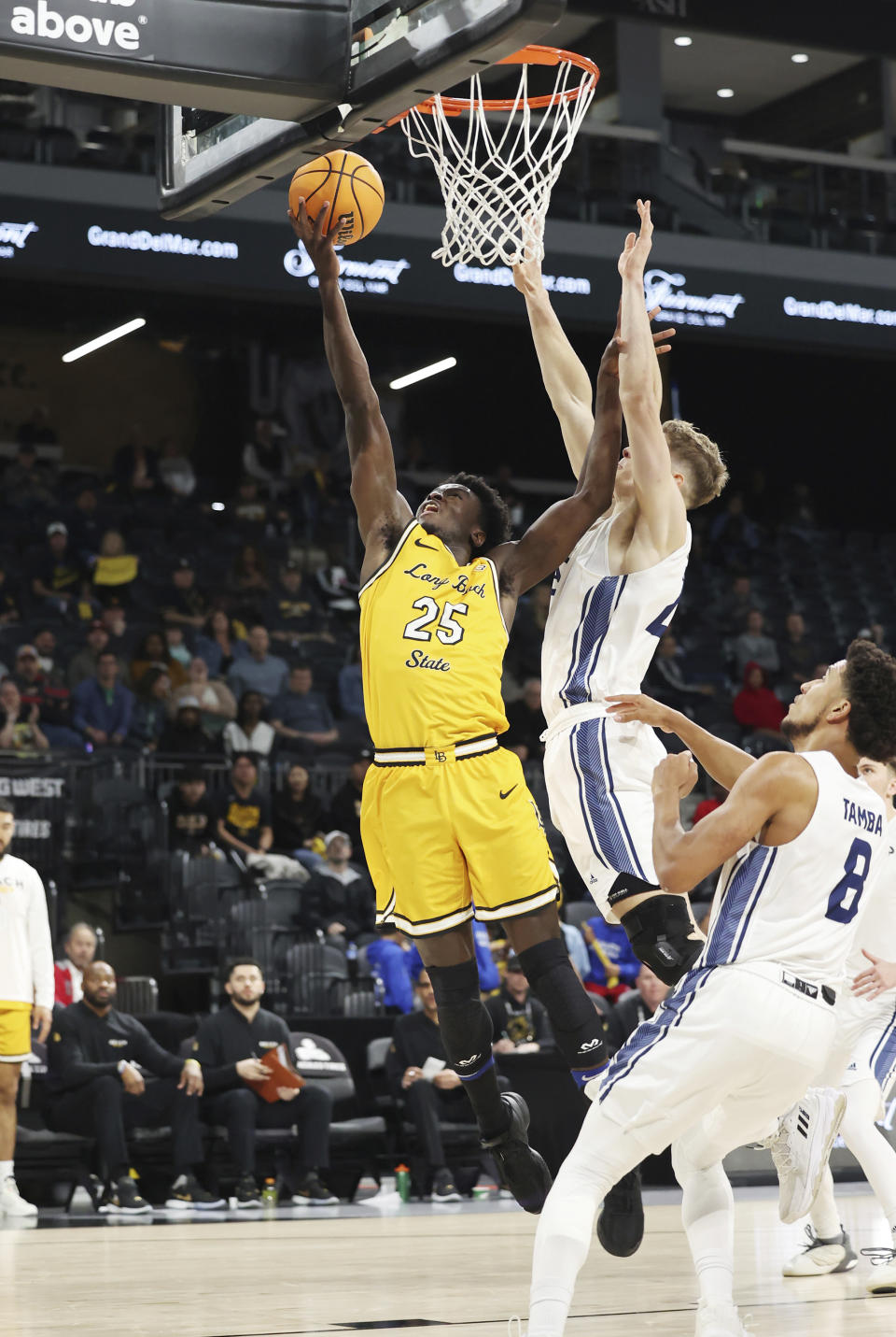 Long Beach State forward Aboubacar Traore (25) goes up for a shot near UC Davis forward Niko Rocak during the second half of an NCAA college basketball game in the championship of the Big West Conference men's tournament Saturday, March 16, 2024, in Henderson, Nev. (AP Photo/Ronda Churchill)