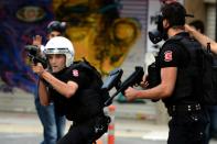 Turkish riot police fire rubber bullets to disperse protesters during a demostration in Istanbul on July 24, 2015