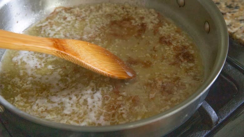 wooden spoon scraping pan