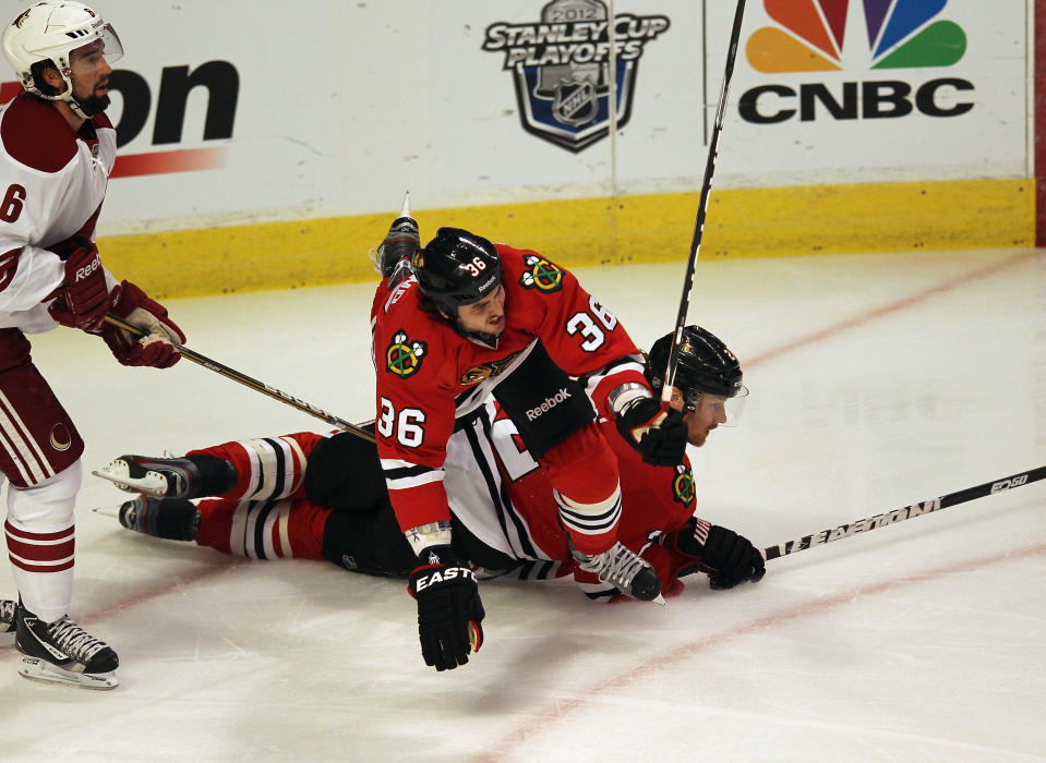 CHICAGO, IL - APRIL 23: Dave Bolland #36 of the Chicago Blackhawks falls over Duncan Keith #2 next to David Schlemko #6 of the Phoenix Coyotes in Game Six of the Western Conference Quarterfinals during the 2012 NHL Stanley Cup Playoffs at the United Center on April 23, 2012 in Chicago, Illinois. (Photo by Jonathan Daniel/Getty Images)