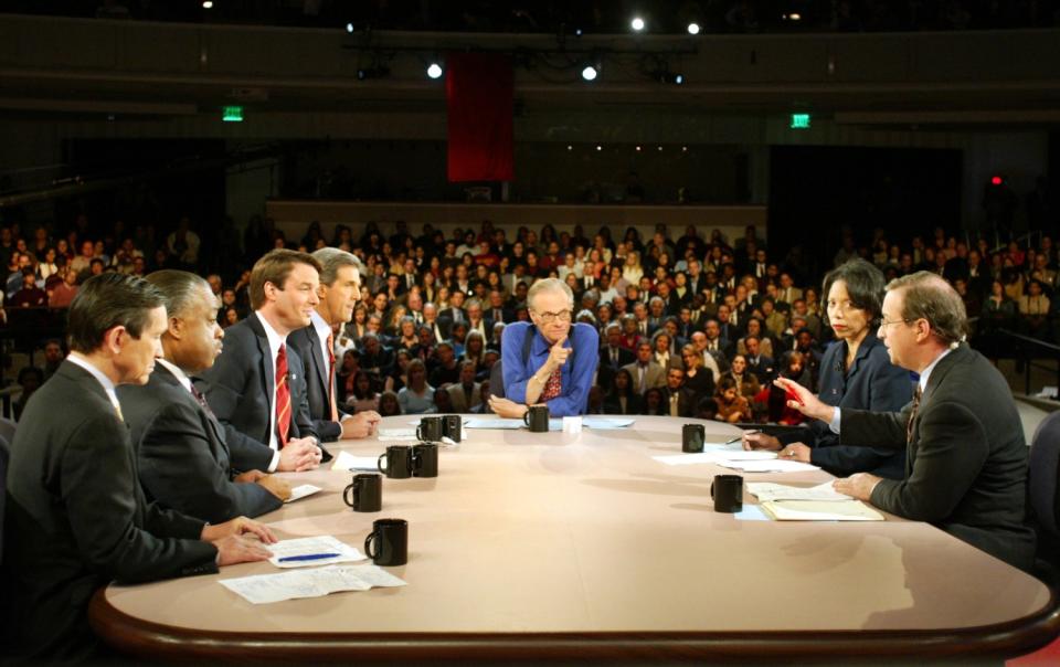 Larry King, center, moderates a debate of U.S. Democratic presidential candidates hosted by the Los Angeles Times in 2004.