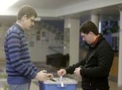 A man casts his vote during Estonia's parliamentary election in Valga March 1, 2015. REUTERS/Ints Kalnins