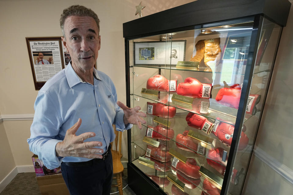 Virginia state Sen. Joe Morrissey gestures in front of his collection of autographed boxing gloves during an interview in his office Monday, May 22, 2023, in Richmond, Va. Morrissey is being challenged in a Democratic primary for a newly-redrawn senatorial district by former Delegate Lashrecse Aird. (AP Photo/Steve Helber)