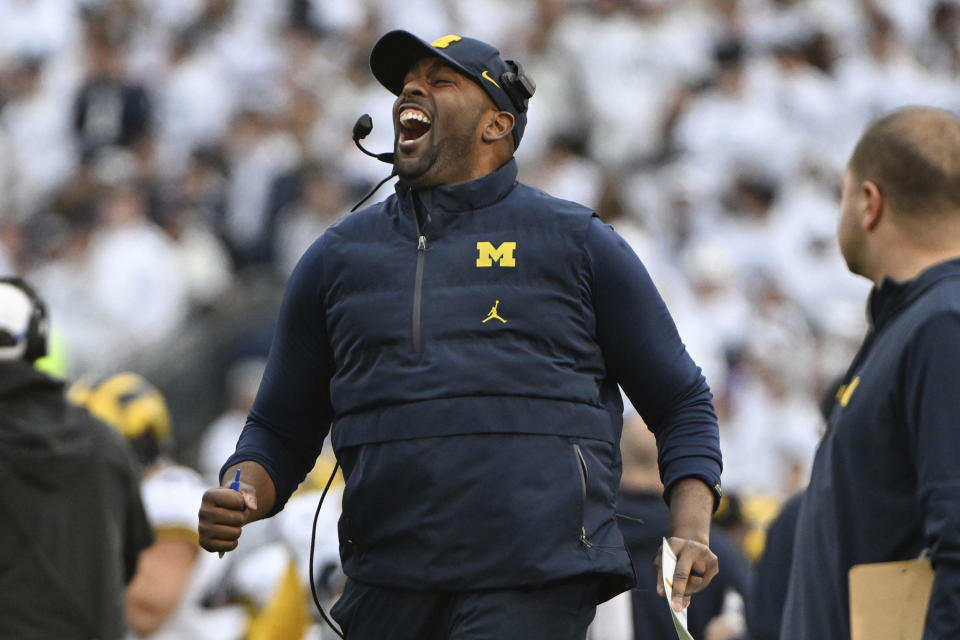 Michigan acting head coach Sherrone Moore celebrates a touchdown against Penn State during an NCAA college football game, Saturday, Nov. 11, 2023, in State College, Pa. (AP Photo/Barry Reeger)