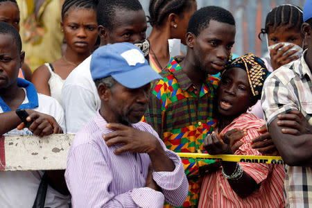 A mother who lost her son during the mudslide gets consoled by a sympathiser near the entrance of Connaught Hospital in Freetown, Sierra Leone August 16, 2017. REUTERS/Afolabi Sotunde