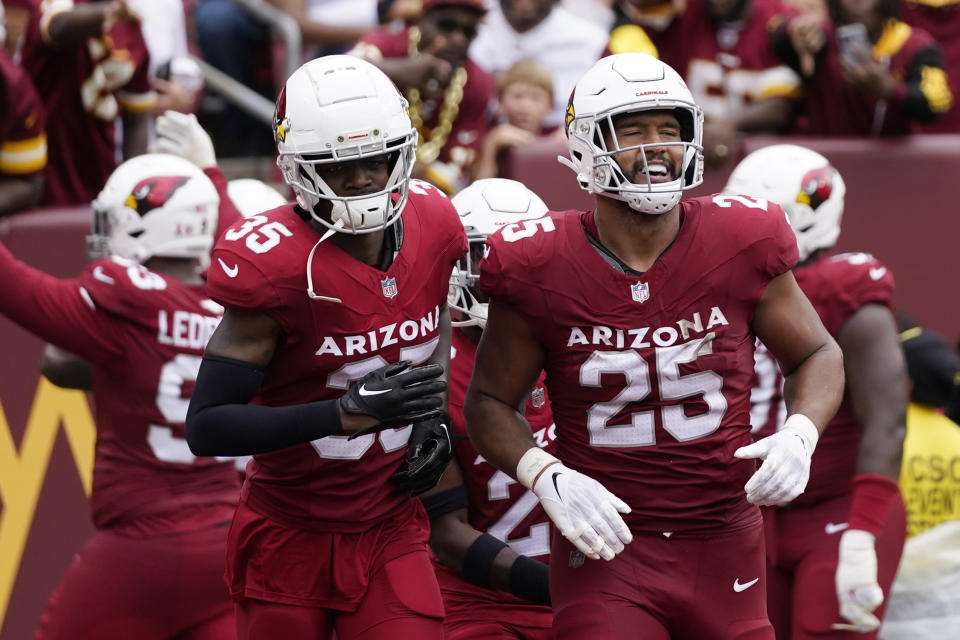 Arizona Cardinals linebacker Zaven Collins (25) celebrates an interception with teammate Arizona Cardinals cornerback Christian Matthew (35) during the first half of an NFL football game against the Washington Commanders, Sunday, Sept. 10, 2023, in Landover, Md. (AP Photo/Alex Brandon)