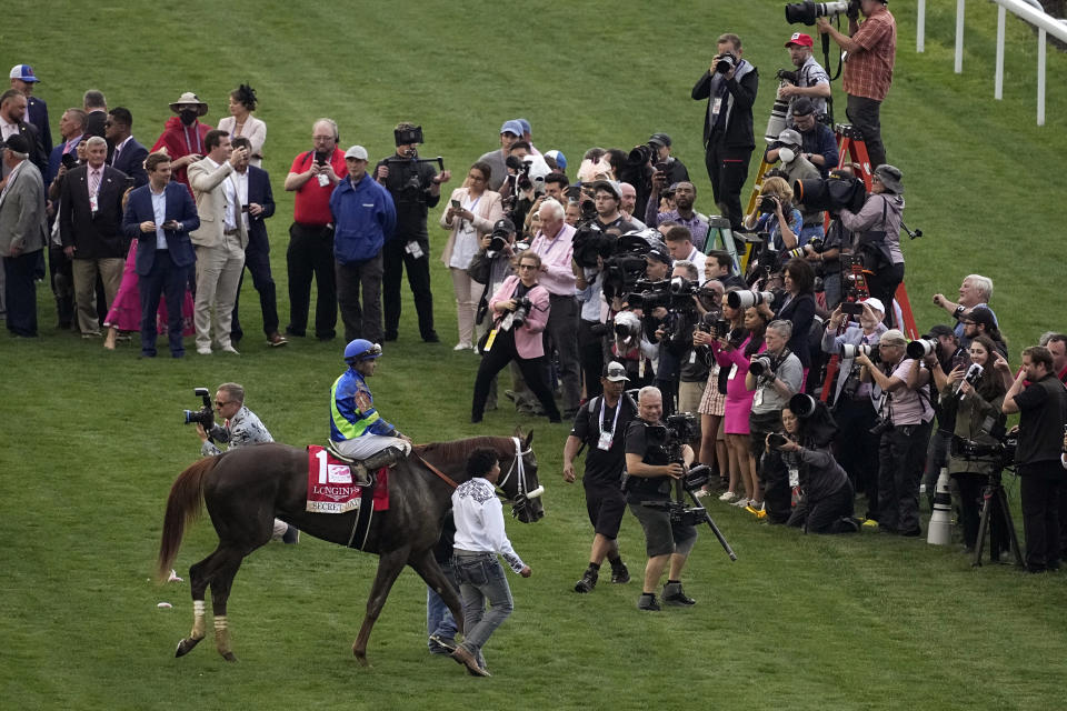 Luis Saez rides Secret Oath to the winners circle after winning the 148th running of the Kentucky Oaks horse race at Churchill Downs Friday, May 6, 2022, in Louisville, Ky. (AP Photo/Charlie Riedel)