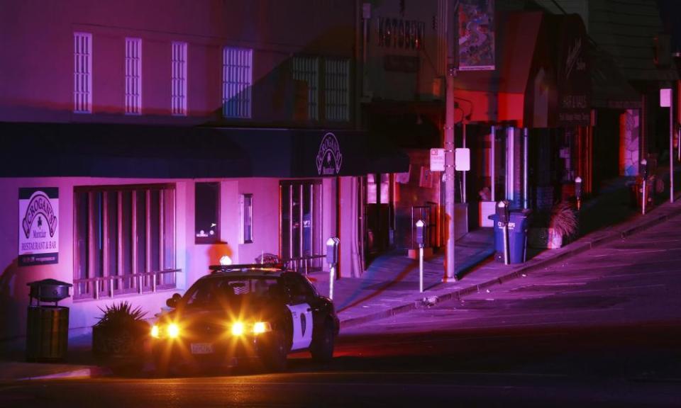 Oakland police officers patrol a street in the Montclair shopping district of Oakland, California.