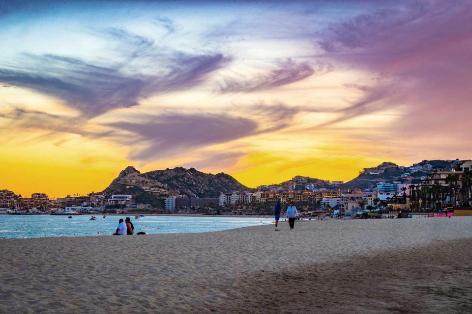 Stunning purple, blue, and yellow sunset over the beach in Cabo San Lucas, Mexico