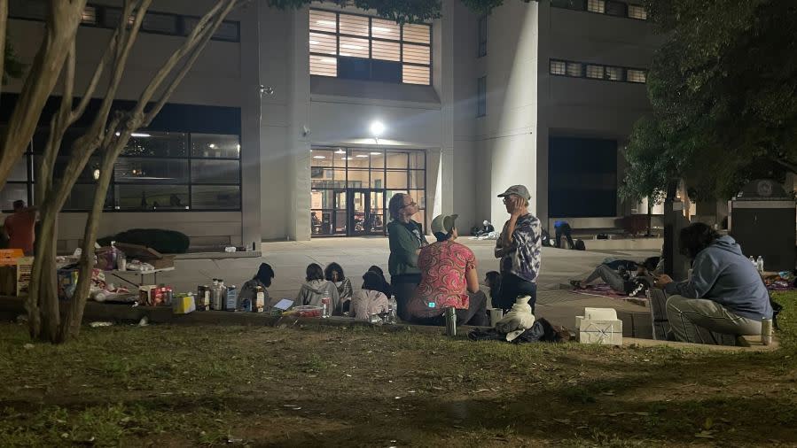 People gathered and waited outside the Travis County Jail overnight into the early hours of Thursday to receive people who were arrested during pro-Palestine protests at UT Wednesday as they began being released Thursday morning. (KXAN Photo/Lauren Ryan)