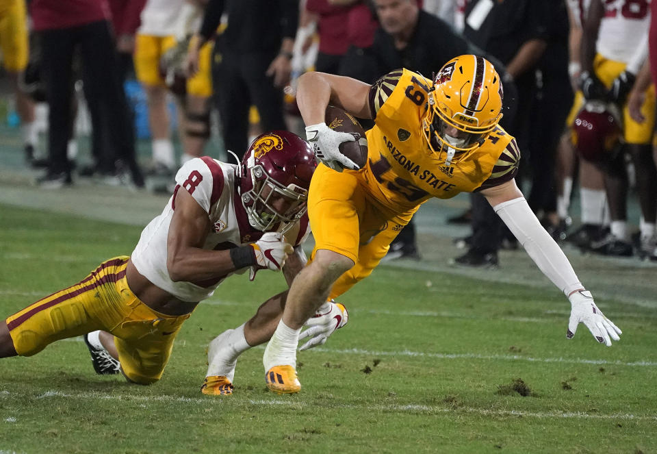 Arizona State receiver Ricky Pearsall (19) fights for extra yardage against Southern California cornerback Chris Steele (8) during the second half of an NCAA college football game Saturday, Nov. 6, 2021, in Tempe, Ariz. (AP Photo/Darryl Webb)