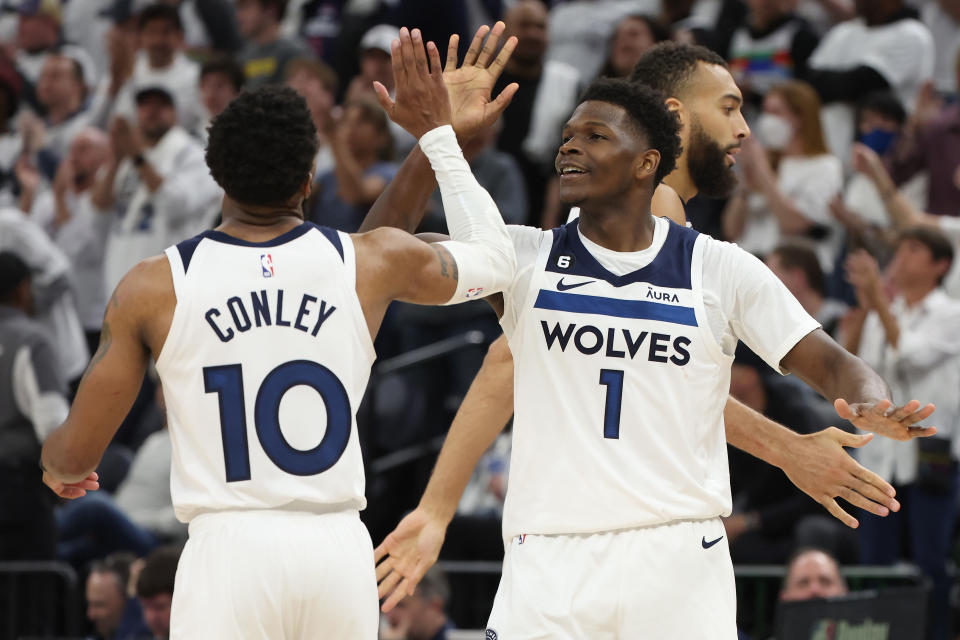 Anthony Edwards, right, and Mike Conley celebrate during Sunday's Timberwolves win over the Nuggets. (Gregory Shamus/Getty Images)