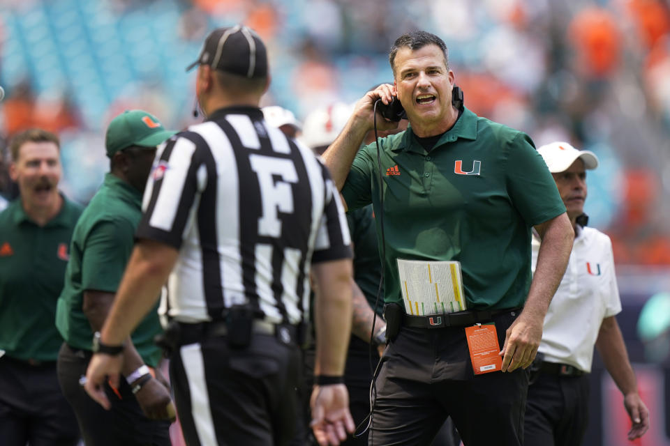 Miami head coach Mario Cristobal, right, argues a call with Field Judge Jake Dishaw during the second half of an NCAA college football game against Southern Miss, Saturday, Sept. 10, 2022, in Miami Gardens, Fla. (AP Photo/Wilfredo Lee)