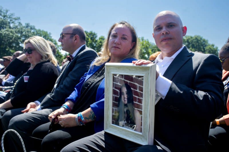 Lori and Ilhan Alhadeff hold a picture of their daughter, Alyssa Alhadeff, a victim of the 2018 Parkland School shooting, during a White House event commemorating the passage of the Bipartisan Safer Communities Acton July 11, 2022. File photo by Bonnie Cash/UPI