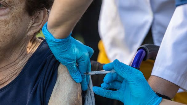 PHOTO: Josefa  Martínez, 87 years old, receives the fourth dose of Covid-19 and flu vaccine in the garden of the nursing home in Feixa Llarga on Sept. 26, 2022 in Barcelona. (Zowy Voeten/Getty Images, FILE)