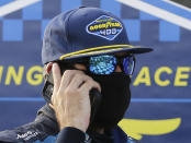 Martin Truex Jr. talks on a cell phone after winning the NASCAR Cup Series auto race at Darlington Raceway, Sunday, May 9, 2021, in Darlington, S.C. (AP Photo/Terry Renna)