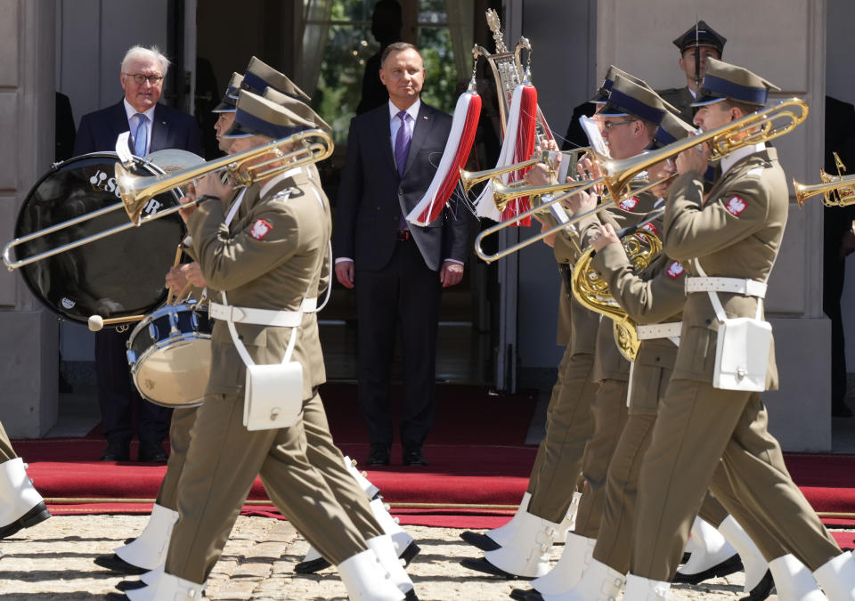 Germany's President Frank-Walter Steinmeier, rear left, and his Polish host, President Andrzej Duda, rear center, attend a military welcome ceremony at the Presidential Palace in Warsaw, Poland, Thursday, June 17, 2021 at the start of Steinmeier's brief visit marking 30 years of bilateral good-neighborly relations treaty. Their talks are expected to include the future of the European Union and its tran-Atlantic ties, the developments in Ukraine and Belarus and the divisive Nord Stream 2 gas pipeline between Russia and Germany. (AP Photo/Czarek Sokolowski)