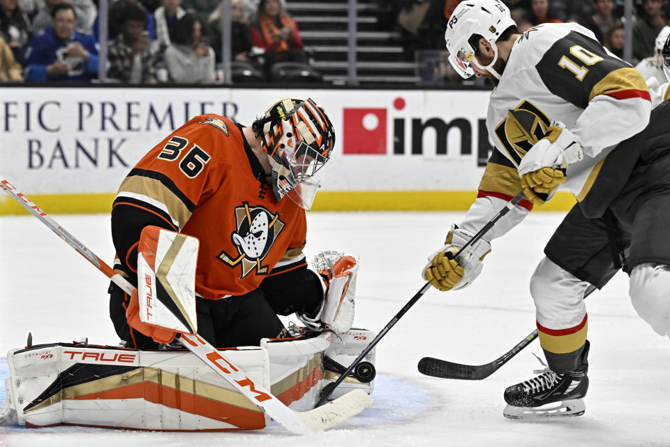 Anaheim Ducks goaltender John Gibson, left, blocks a shot by Vegas Golden Knights center Nicolas Roy during the second period of an NHL hockey game in Anaheim, Calif., Wednesday, Dec. 28, 2022. (AP Photo/Alex Gallardo)