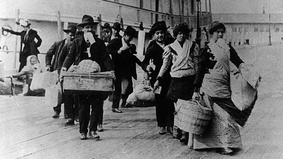 Italian immigrants disembark at Ellis Island in the early 1900s. Officials then echoed the racist notion that southern Italians were inherently inferior. - SeM/Universal Images Group/Getty Images
