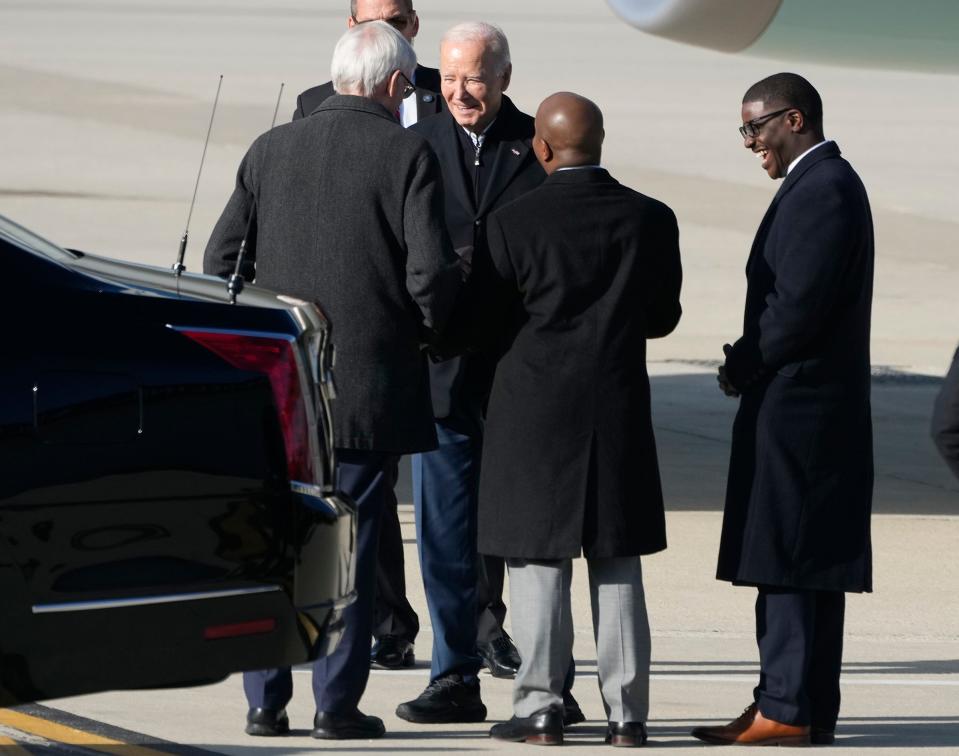 President Joe Biden (facing) greets Gov. Tony Evers (left), Milwaukee Mayor Cavalier Johnson, and Milwaukee County Executive David Crowley at Milwaukee Mitchell International Airport in Milwaukee on Wednesday, Dec. 20, 2023. President Biden will deliver remarks Wednesday at the Wisconsin Black Chamber of Commerce in Milwaukee centering on how his economic policies have led to recent business growth in underrepresented communities.