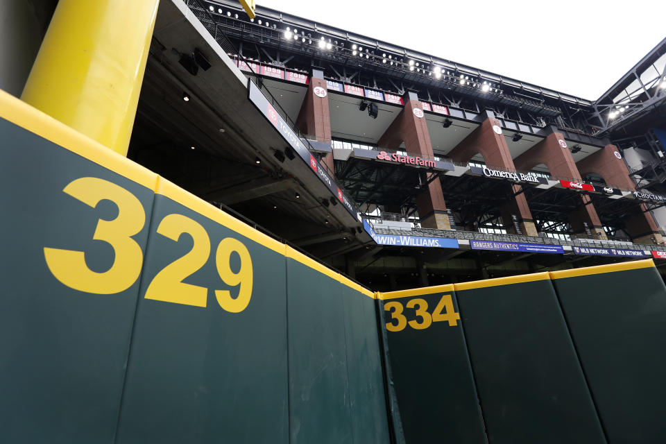 Distance markers on the outfield wall and the foul pole, top left, frame the upper center field concourses at Globe Life Field, the newly-built home of the Texas Rangers, in Arlington, Texas, Wednesday, May 20, 2020. The park that was supposed to have its home opener on March 31 against the Los Angeles Angels has yet to see one game played in it this season amid the coronavirus pandemic. (AP Photo/Tony Gutierrez)