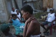 Ramonita Charles talks with her neighbors at the Batey La Lecheria, a community of Haitian descendants, west of Santo Domingo, Dominican Republic, Monday, Nov. 22, 2021. Charles sells eggs, chips, cookies and other small items out of a tin shack to sustain her four siblings, three children and her mother, a former sugarcane worker who is in her early 90s. “You go out and you don’t know if you’re going to come back home,” she said referring to the recent spike in deportations. (AP Photo/Matias Delacroix)