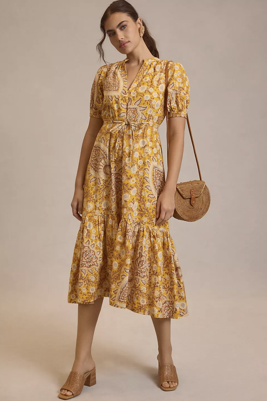 brunette model wearing yellow printed midi dress, By Anthropologie Printed Puff-Sleeve Dress (Photo via Anthropologie)