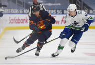 Edmonton Oilers' Ethan Bear (74) and Vancouver Canucks' Elias Pettersson (40) vie for the puck during the second period of an NHL hockey game Wednesday, Jan. 13, 2021, in Edmonton, Alberta. (Dale MacMillan/The Canadian Press via AP)