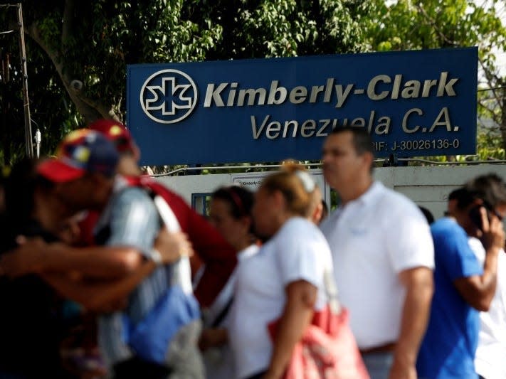 Kimberly-Clark employees stand outside the company in Maracay, Venezuela, July 10, 2016. REUTERS/Carlos Jasso