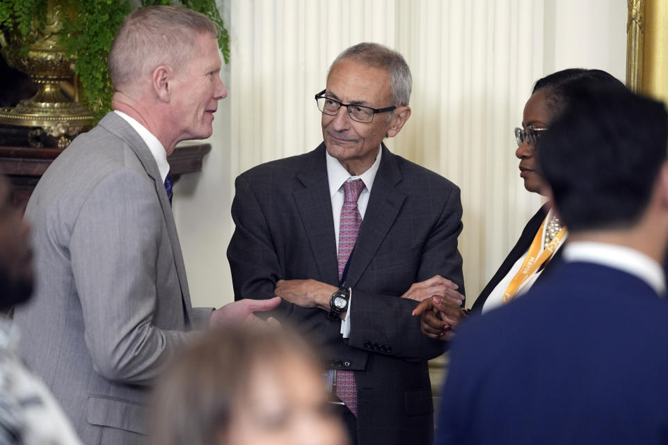 John Podesta talks before President Joe Biden speaks in the East Room during an event to welcome mayors attending the U.S. Conference of Mayors Winter Meeting to the White House, Friday, Jan. 19, 2024, in Washington. (AP Photo/Evan Vucci)