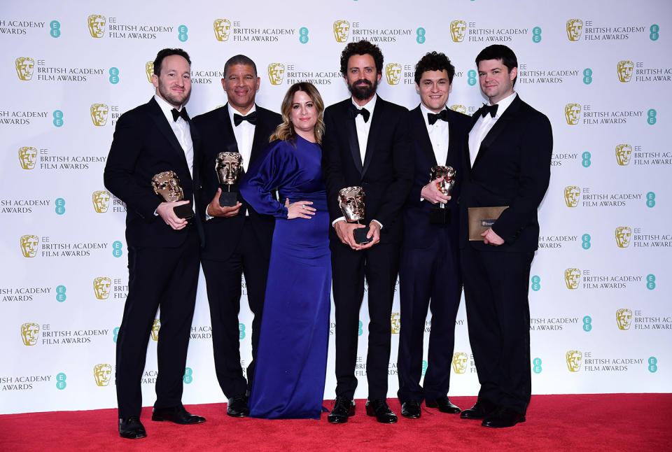 The crew of <i>Spider-Man: Into the Spider-Verse</i> with their Best Animated Film bafta in the press room at the 72nd British Academy Film Awards. (Ian West/PA)