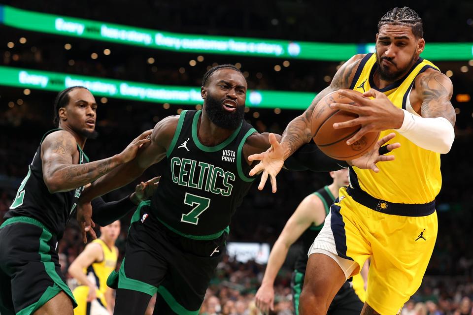 BOSTON, MASSACHUSETTS - NOVEMBER 01: Jaylen Brown #7 of the Boston Celtics and Obi Toppin #1 of the Indiana Pacers battle for control of the ball during the second quarter at TD Garden on November 01, 2023 in Boston, Massachusetts.