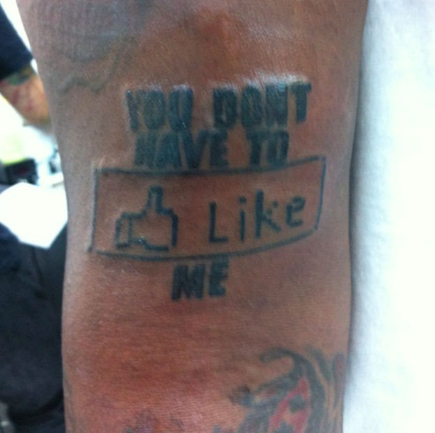 The actual tat: "You don't have to like me," with "like" in the form of a thumbs-up Facebook like