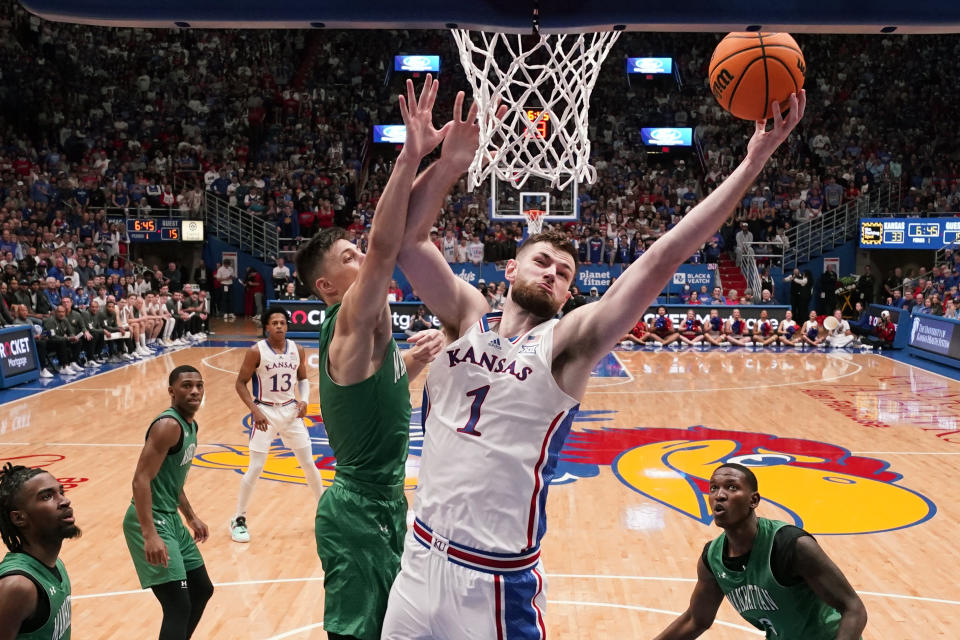 Kansas center Hunter Dickinson (1) dunks the ball during the first half of an NCAA college basketball game against Manhattan Friday, Nov. 10, 2023, in Lawrence, Kan. (AP Photo/Charlie Riedel)