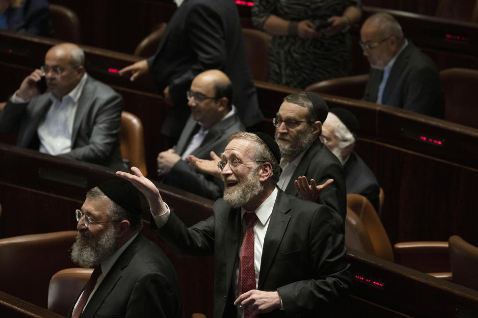 Lawmakers celebrate the defeat of a law on the legal status of Jewish settlers in the occupied West Bank, during a session of the Knesset, Israel's parliament, in Jerusalem, Monday, June 6, 2022. (AP Photo/ Maya Alleruzzo)