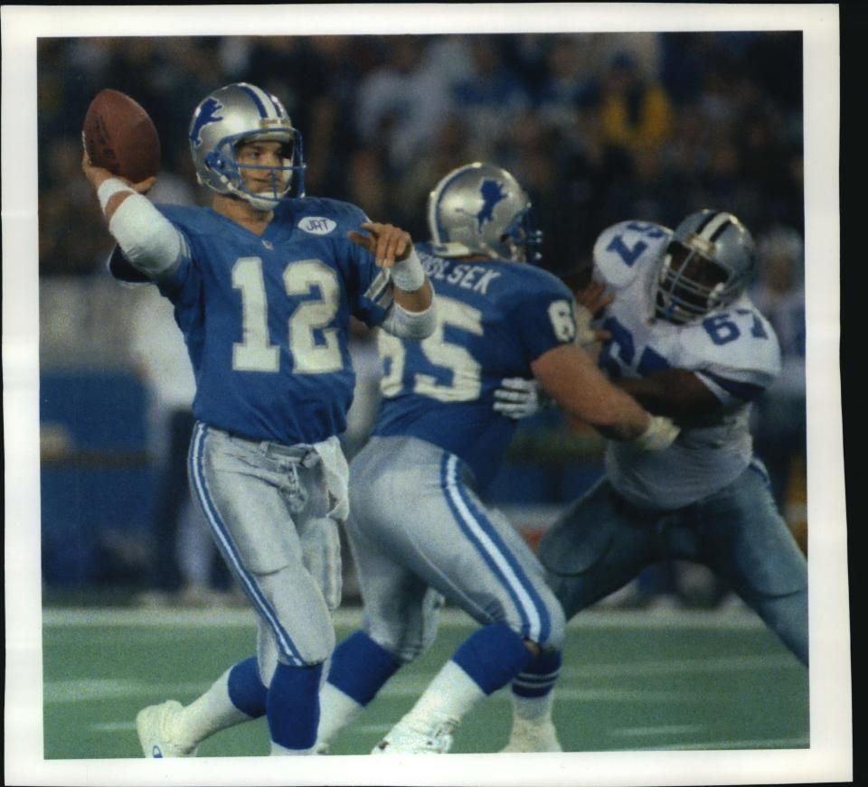 Detroit Lions quarterback Erik Kramer receives good protection from guard Eric Andolsek, blocking against Dallas' Russell Maryland during a playoff game at the Silverdome in Pontiac, Michigan. The Lions crushed the Cowboys, 38-6.