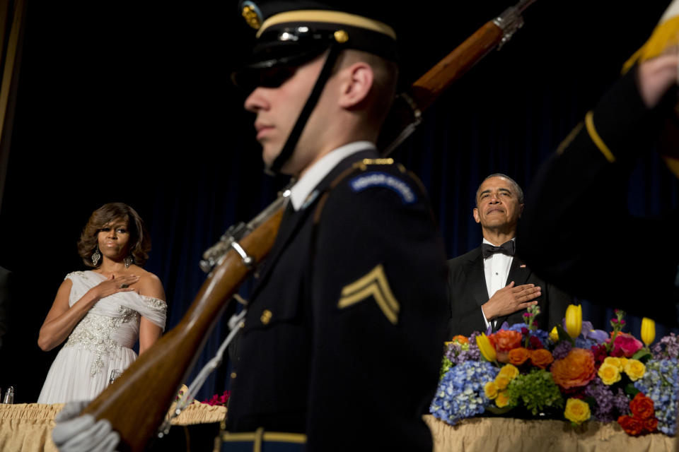 President Barack Obama, right, and first lady Michelle Obama stand for the honor guard during the White House Correspondents' Association (WHCA) Dinner at the Washington Hilton Hotel, Saturday, May 3, 2014, in Washington. (AP Photo/Jacquelyn Martin)