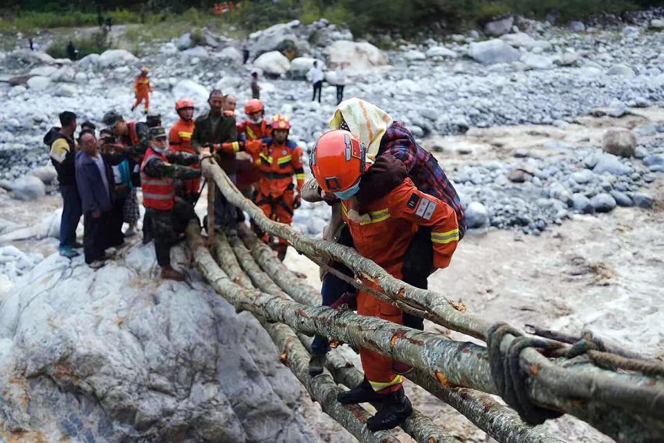 This photo taken on September 5, 2022 shows rescue workers evacuating residents after a 6.6-magnitude earthquake in Luding county, Ganzi, in China's southwestern Sichuan province