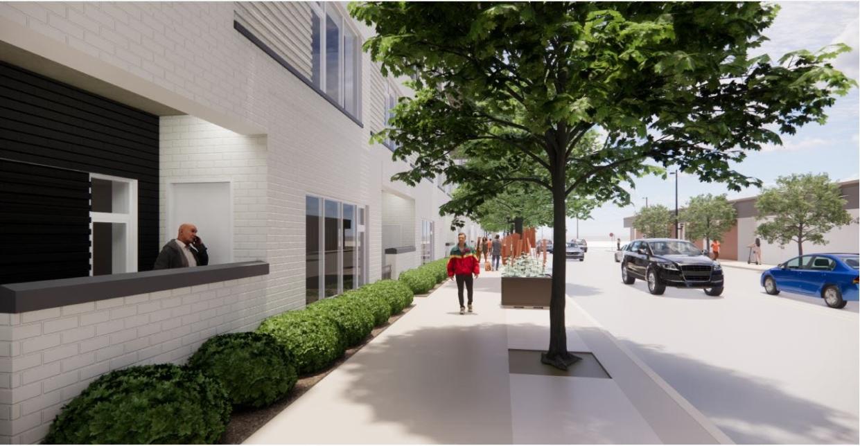 A rendering of a tentative eight-story, downtown Green Bay luxury apartment building shows first-floor townhouse rental units along Cherry Street. New Land Enterprises and the city of Green Bay continue to work on a development agreement for the project in April 2024.