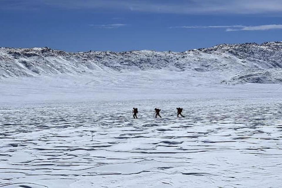 This March 2, 2023, image released by Inyo County Search and Rescue (InyoSAR) shows InyoSAR members searching for a missing person near an area along Death Valley Road, a rough road running south of the 168, and leading into Death Valley National Park, Calif. The California Highway Patrol identified a cell phone ping linked to the missing person, Thursday, March 2, and sent a helicopter crew that spotted a partly snow-covered vehicle with the man waving inside, sheriff's authorities said in a statement. (InyoSAR via AP)