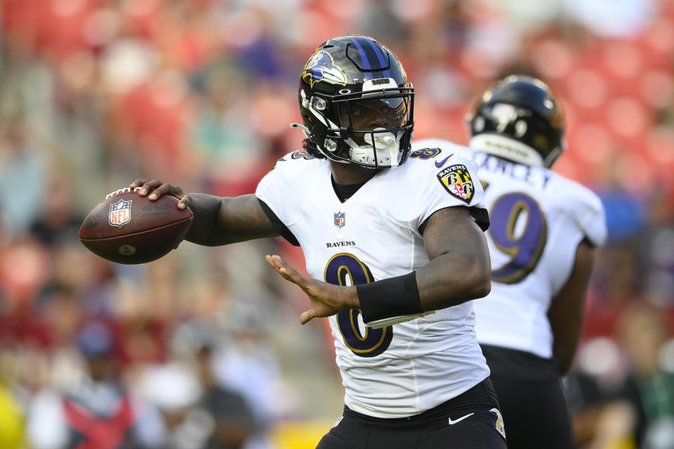 Baltimore Ravens quarterback Lamar Jackson looks downfield before throwing the ball against the Washington Football Team during the first half of a preseason NFL football game, Saturday, Aug. 28, 2021, in Landover, Md. (AP Photo/Nick Wass)