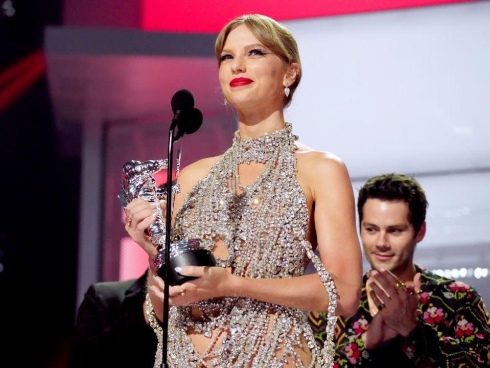 Taylor Swift accepts a VMA award for video of the year in 2022