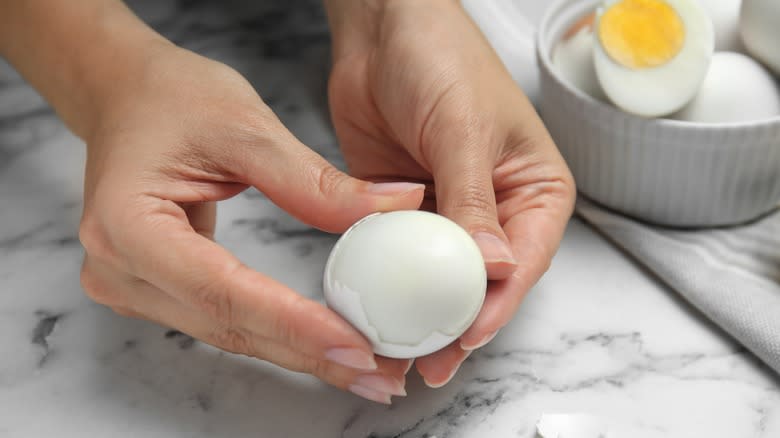 Hand peeling egg