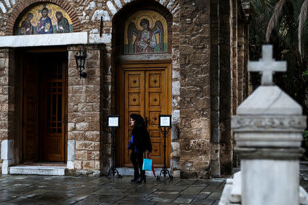 A woman walks outside a church at the Asomaton-Petraki monastery in Athens, Greece, February 7, 2017. REUTERS/Alkis Konstantinidis